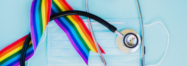 Stethoscope and LGBT rainbow ribbon pride symbol. Blue background