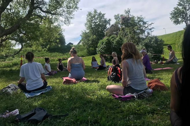 July Huang teaching an outdoor yoga class