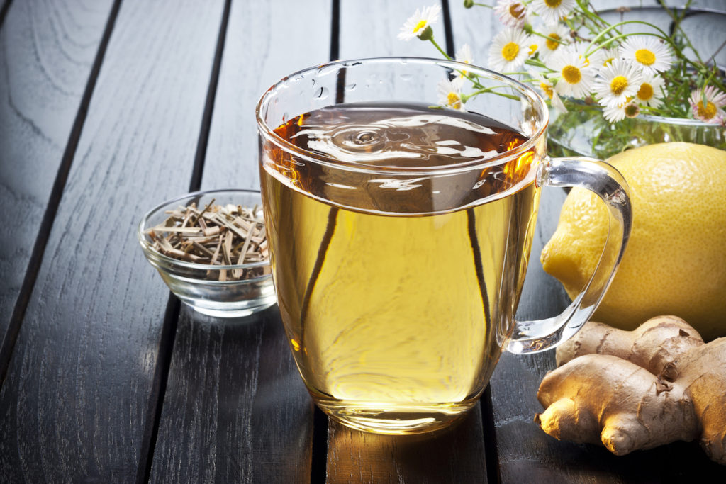 Clear glass cup with ginger and lemon tea