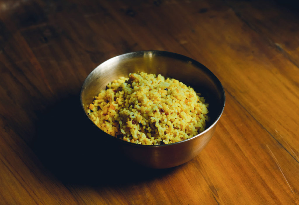 a bowl of kitchari on a wooden table